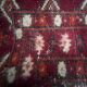 Antique wool rugs with designs on a red background, 20th century.