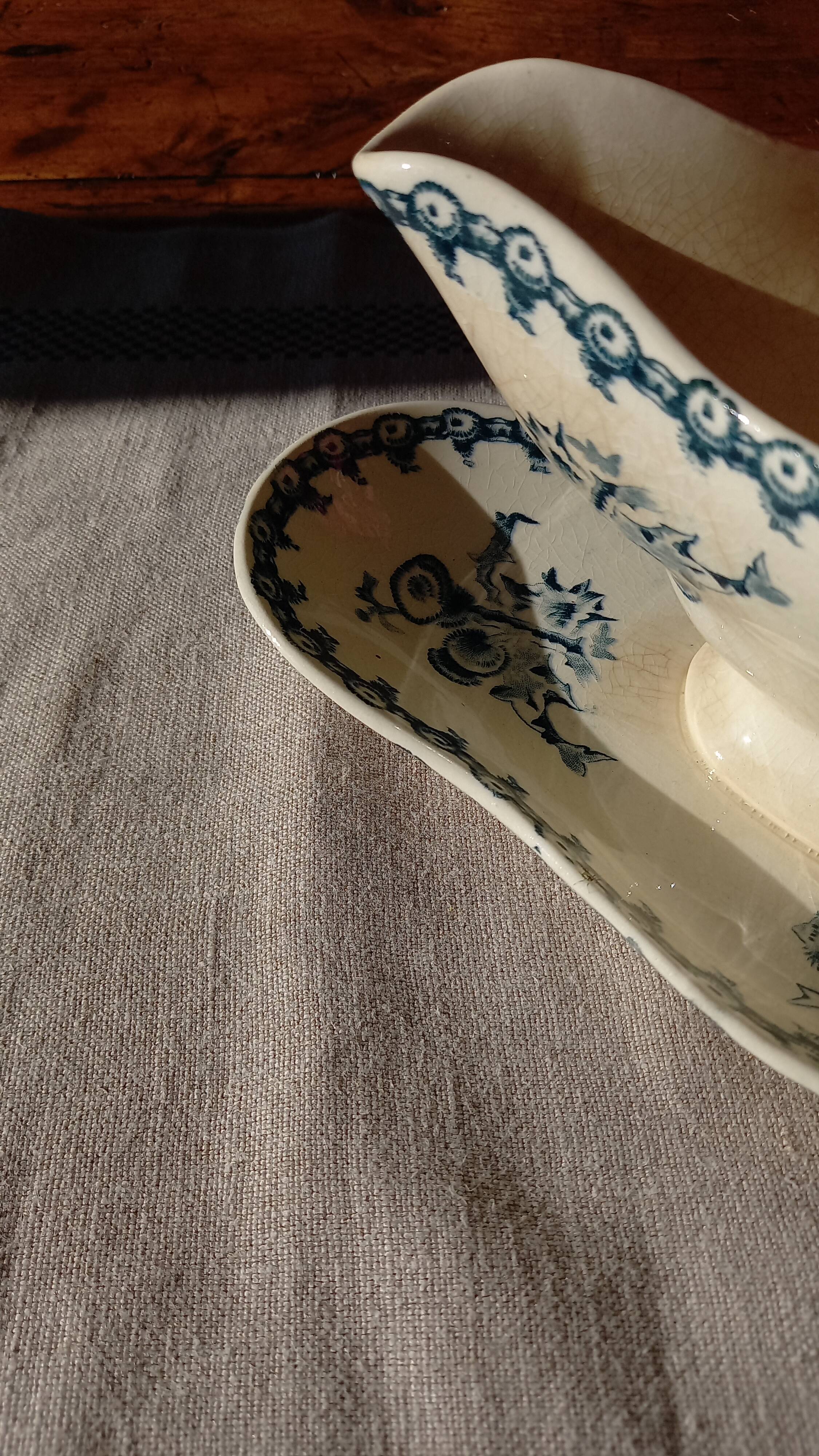 Old gravy boat on frame in terre de fer earthenware by gien, “chardons” model in blue-green