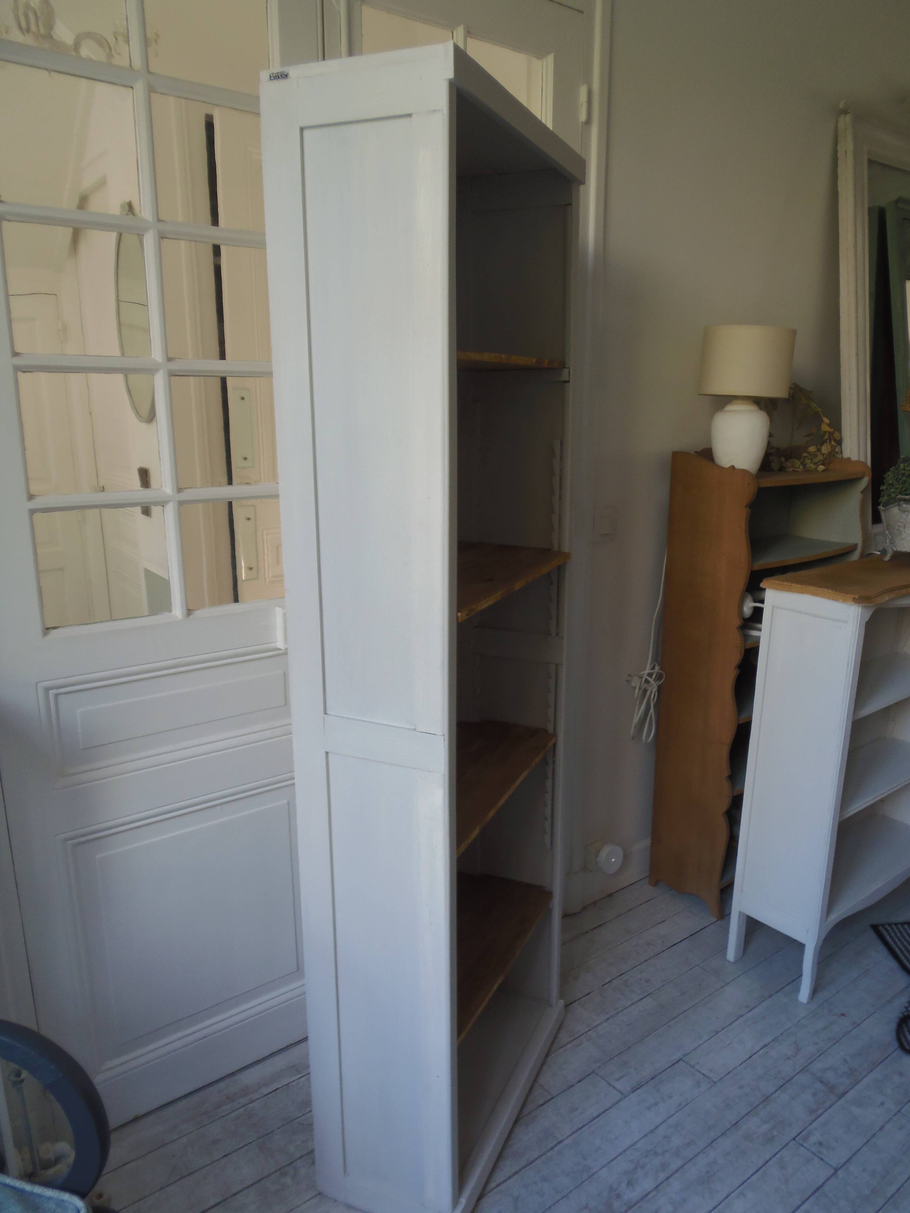 Shallow depth bookcase re-enchanted in pearl gray, wooden shelves.