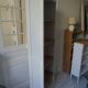 Shallow depth bookcase re-enchanted in pearl gray, wooden shelves.