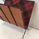 Magazine rack in black lacquered metal, leather and checkered fabric