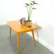 Vintage veneer table with pretty angular legs and brass at the base of the legs.