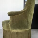 Olive green toad armchair with smooth velvet fringes.