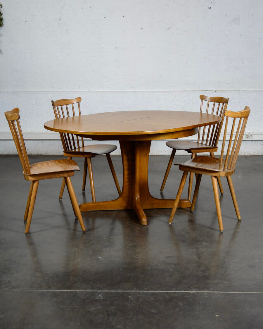 Round teak table with an extension.