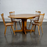 Round teak table with an extension.