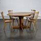 Round teak table with an extension.