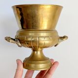 Vintage brass cache-pot on a stand with handles, classic decor.