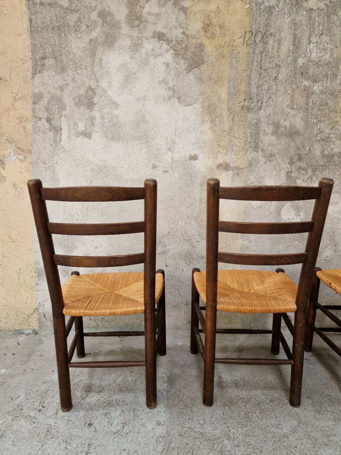 4 wooden and straw chairs