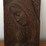Carved wooden plaque representing a Madonna with folded hands