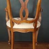 Upholsterer armchair covered with a publisher fabric with a central floral pattern