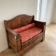 Traditional two-seater bench in solid wood with storage compartment.