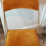 Two gold velvet folding chairs