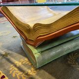 Coffee table with a base in the shape of books