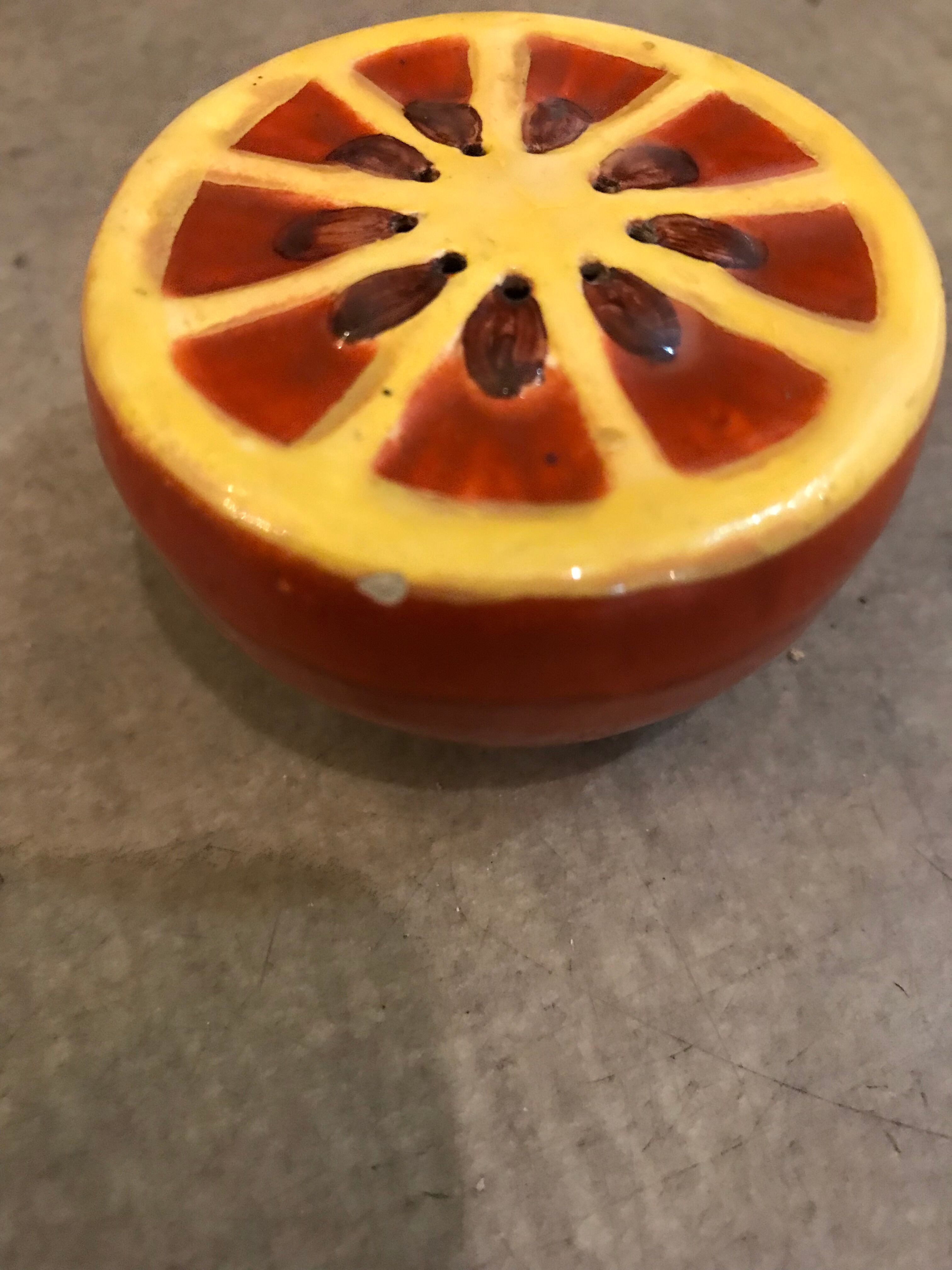 Vintage salt shaker in the shape of an orange marked ermetic