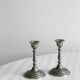 Pair of small metal candle holders, classic design.