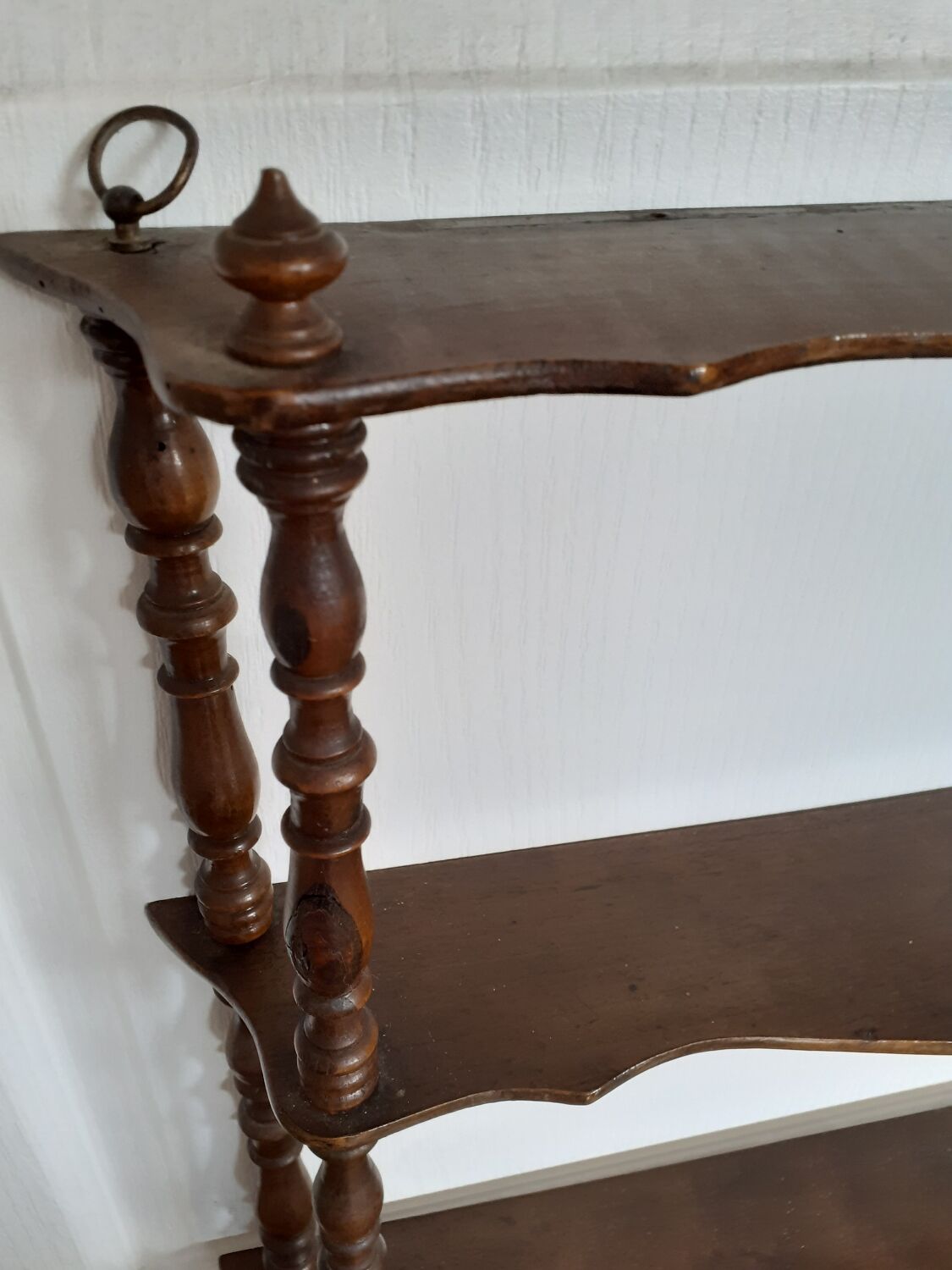 Turned wooden wall shelf