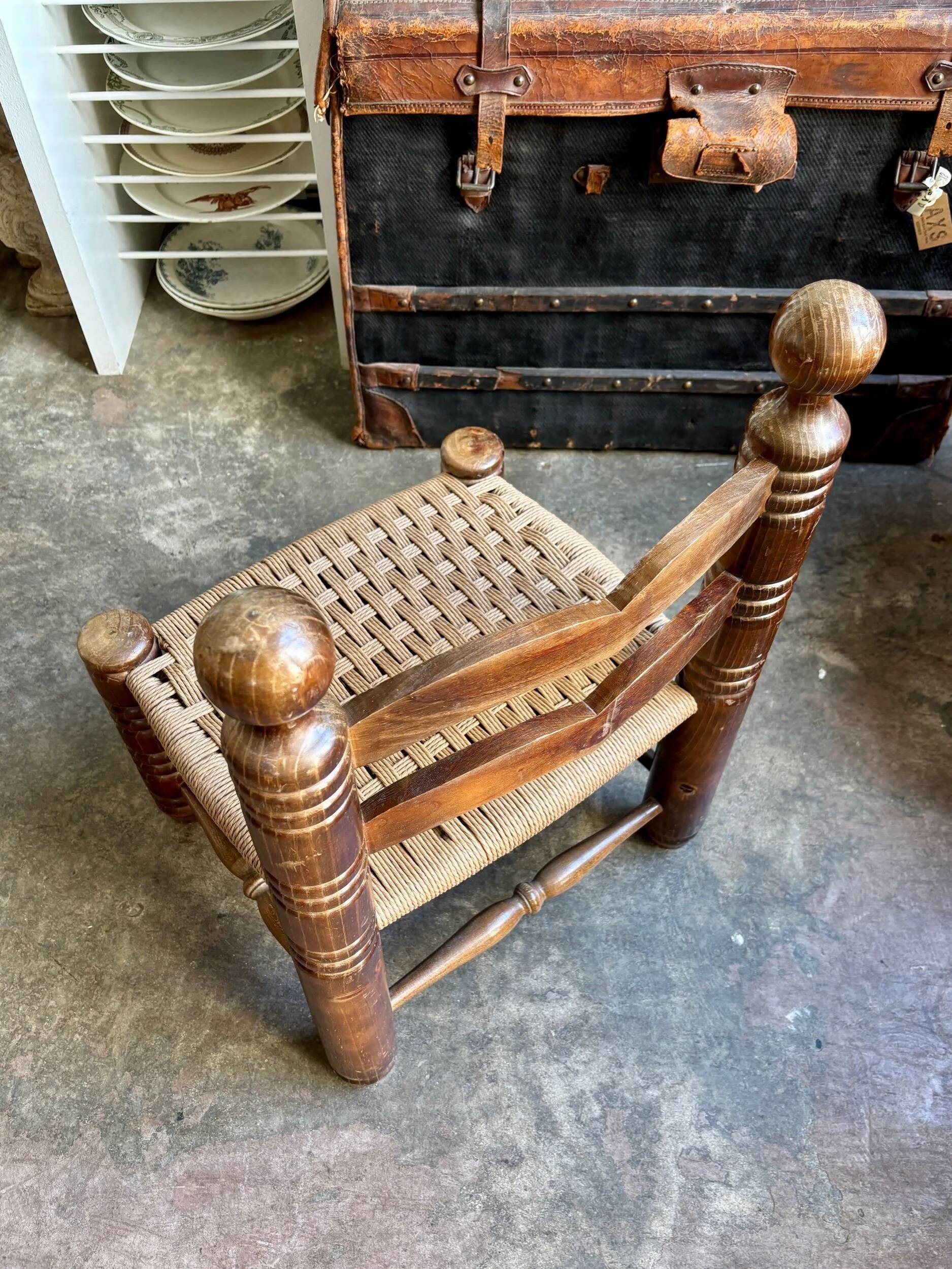 Low chair in dark wood and woven Danish cord attributed to Charles Dudouyt.