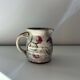 Floral decorated pitcher signed
