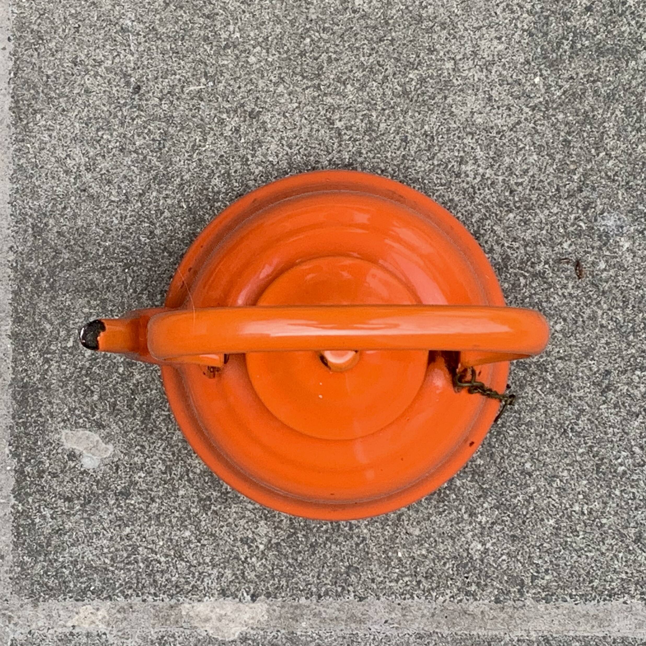 Vintage orange enameled sheet metal kettle