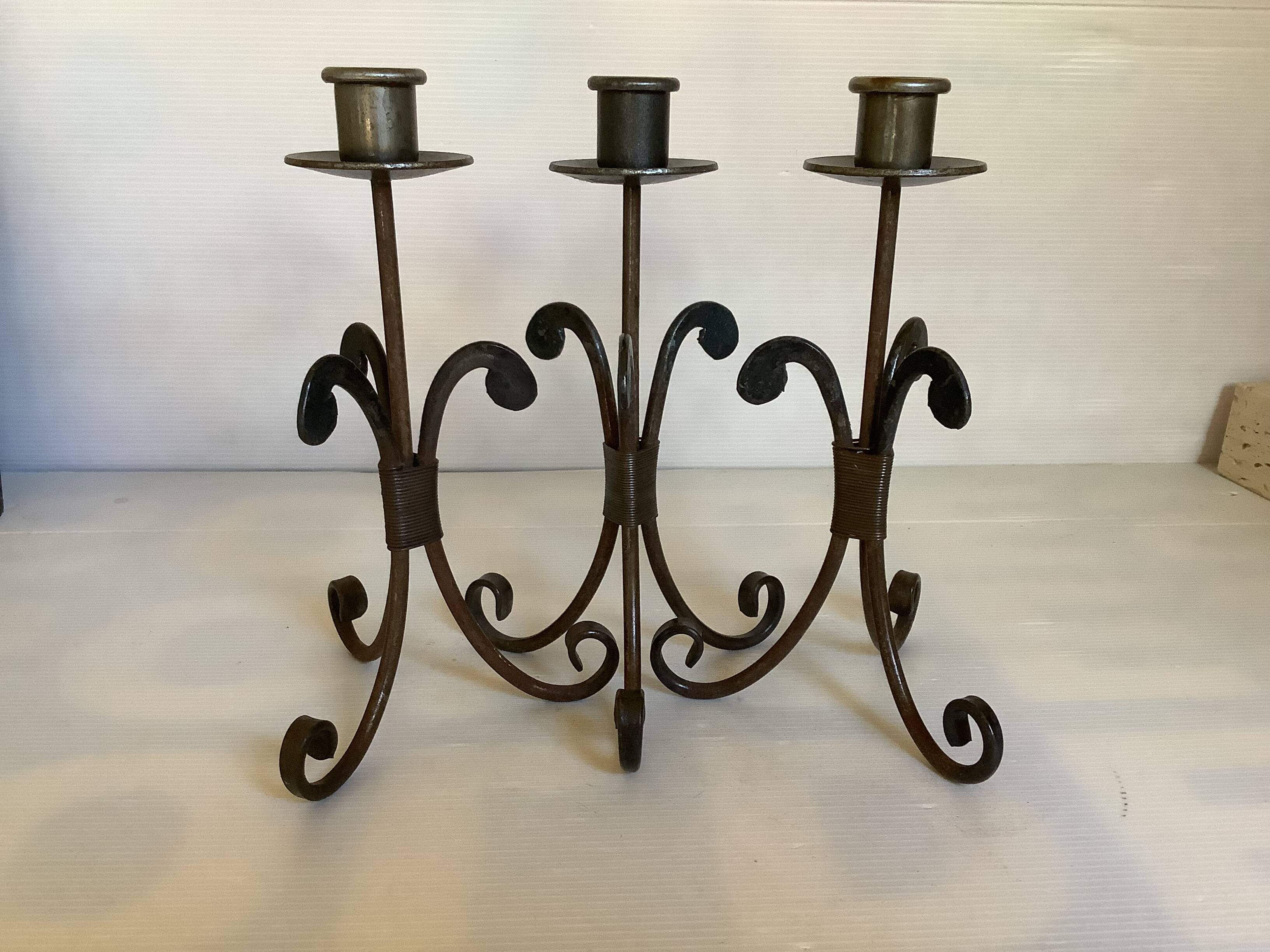 Trio of wrought iron candlesticks