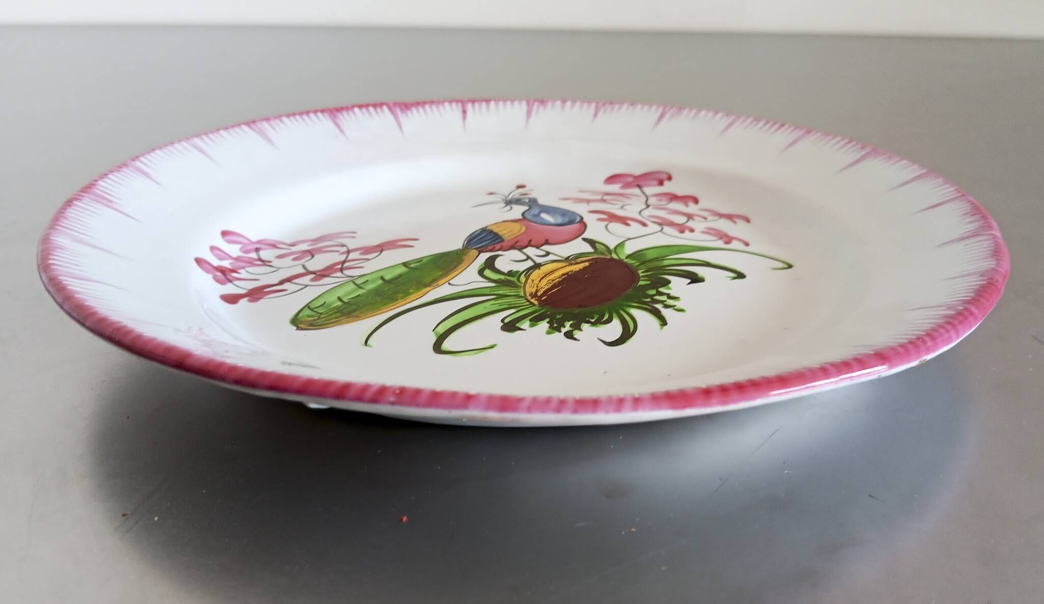 Rare Les Islettes earthenware plate decorated with a peacock. 19th century.