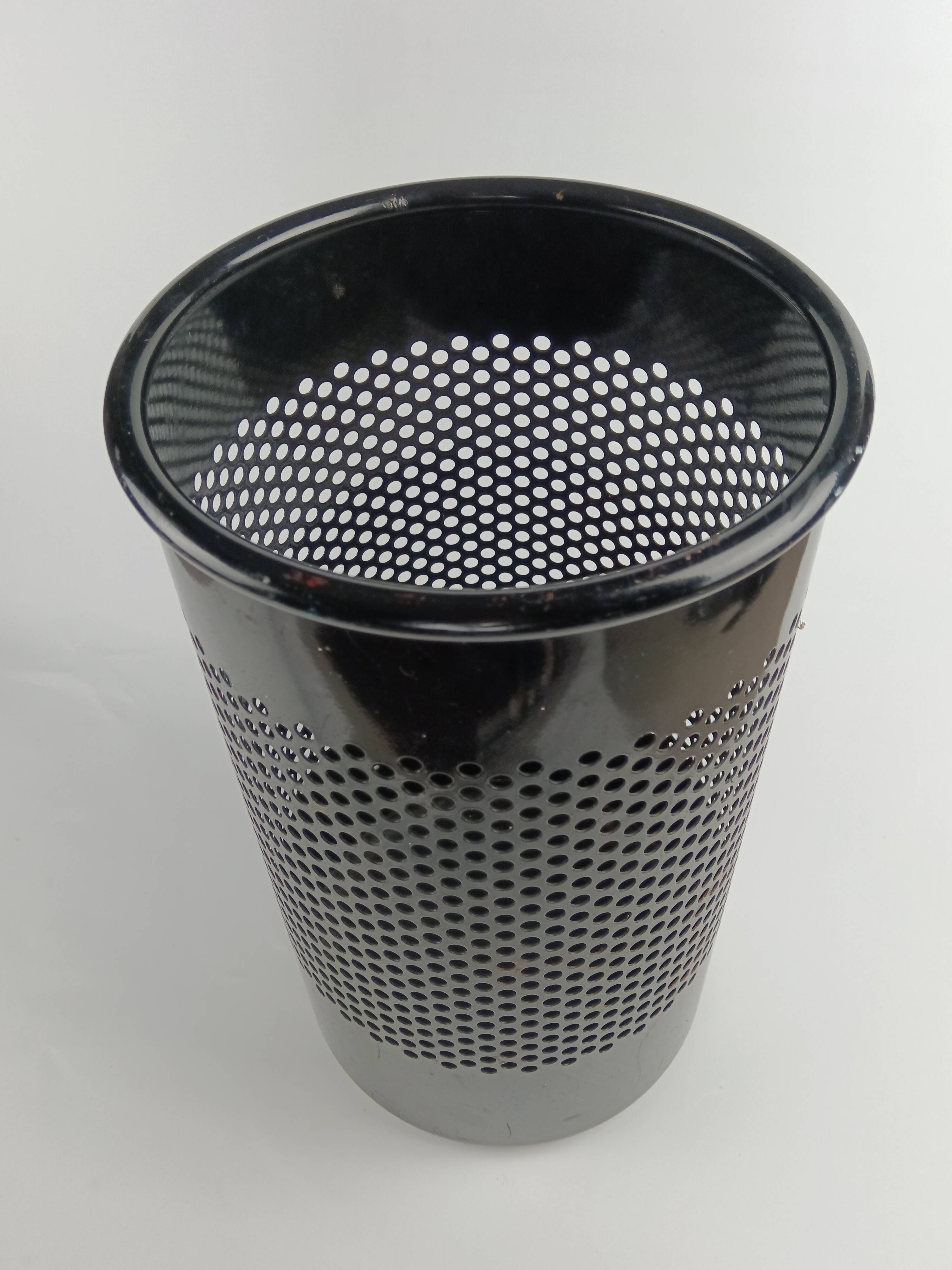 Perforated metal wastebasket