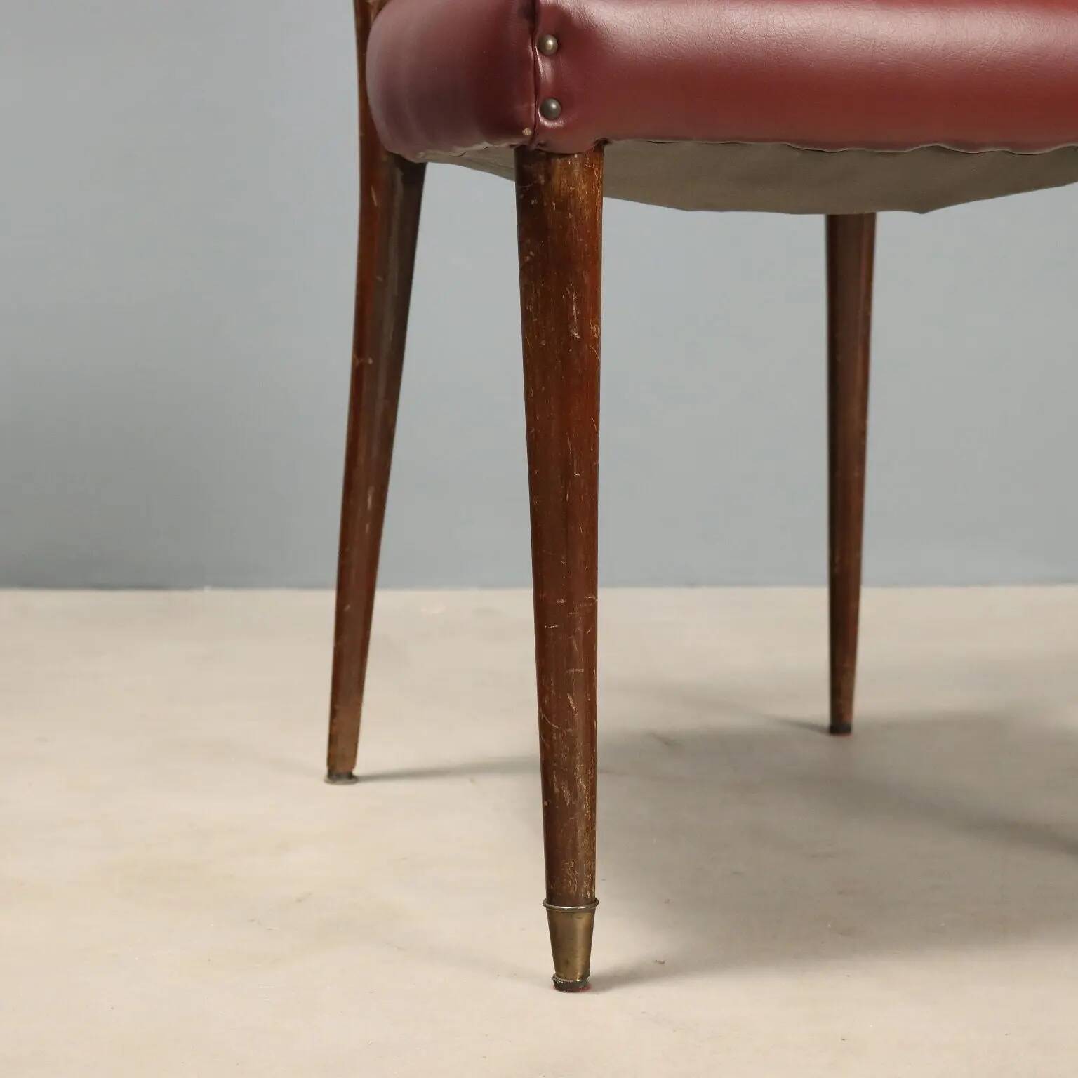 Set of six 1950s chairs with burgundy seats.