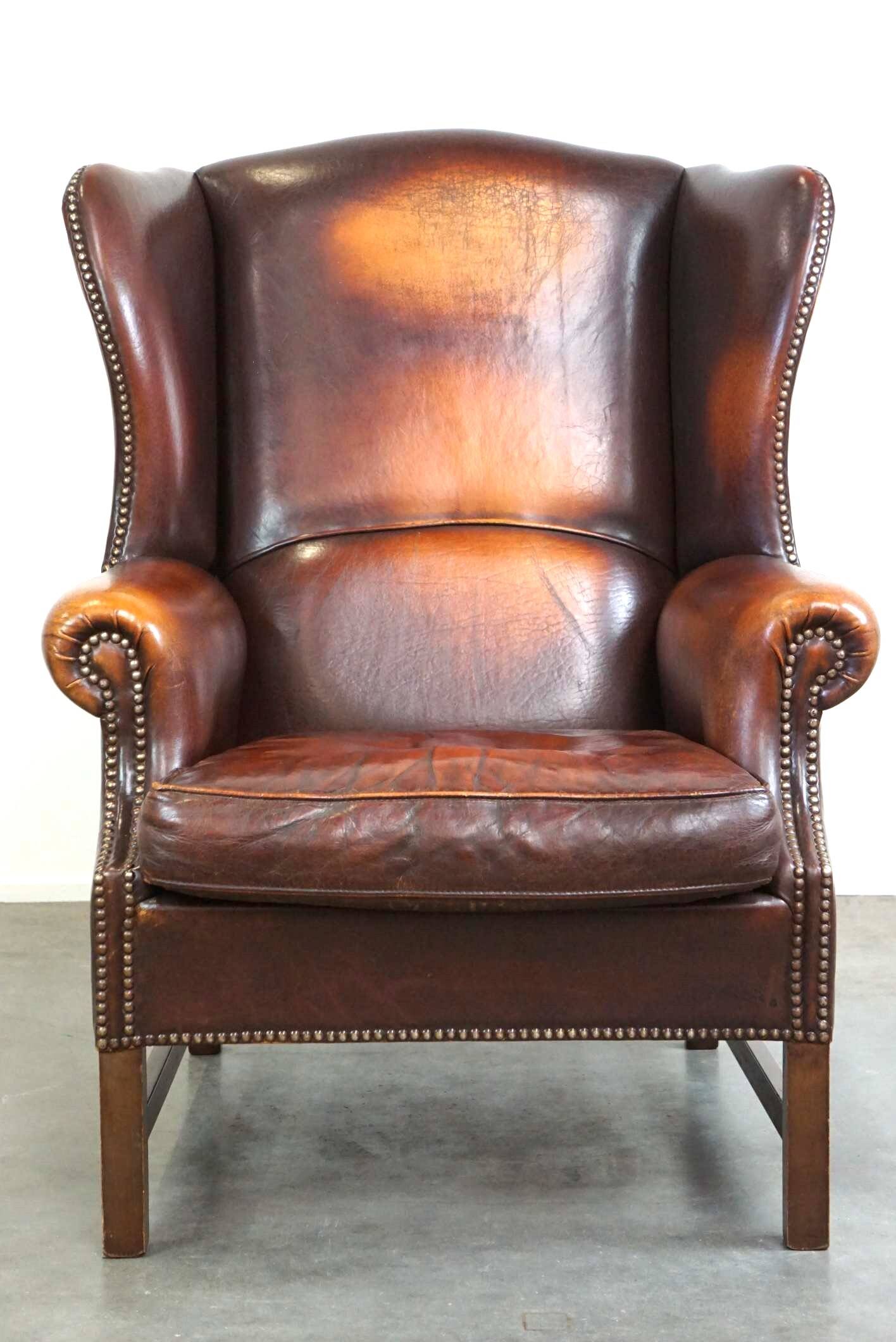 Beautiful classic and stately wingback armchair made of sheep leather with beautiful colors