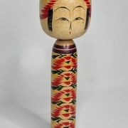 Japanese Kokeshi doll dated 1986, signed and numbered, hand-painted multi-colored floral decoration,