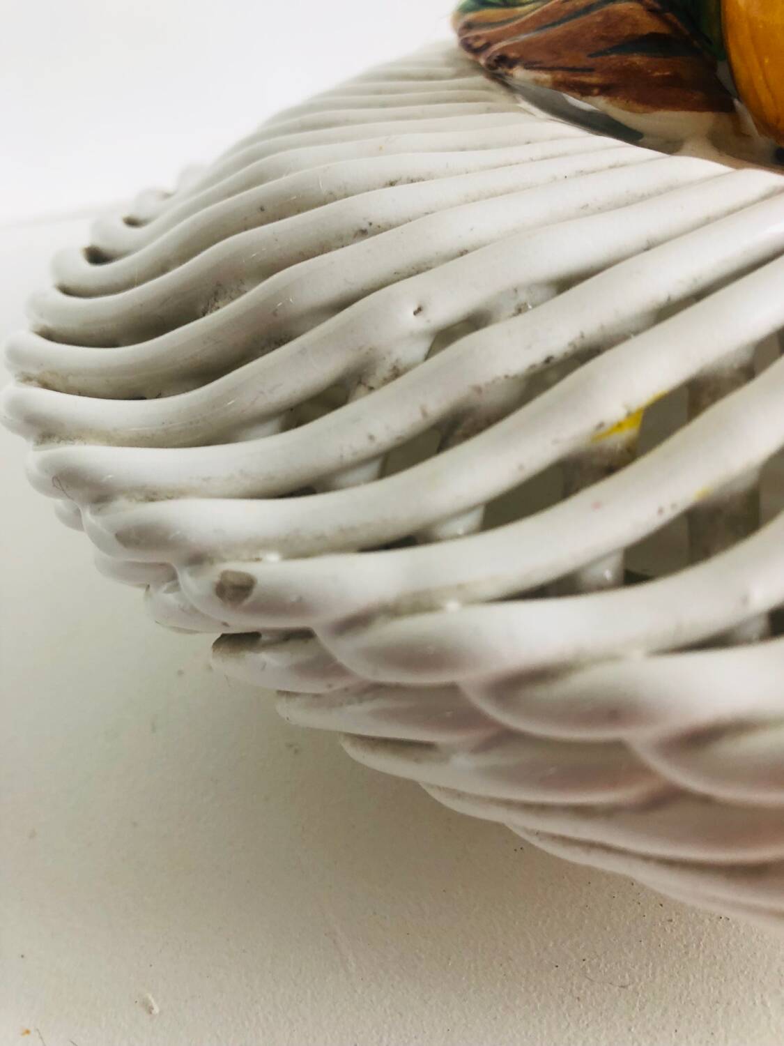 Covered basket in woven ceramic and fruit slip.