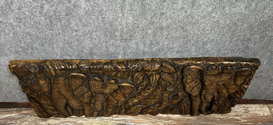 Central Africa 20th century: carved wooden panel in bas-relief of elephants