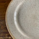 Four beige speckled plates