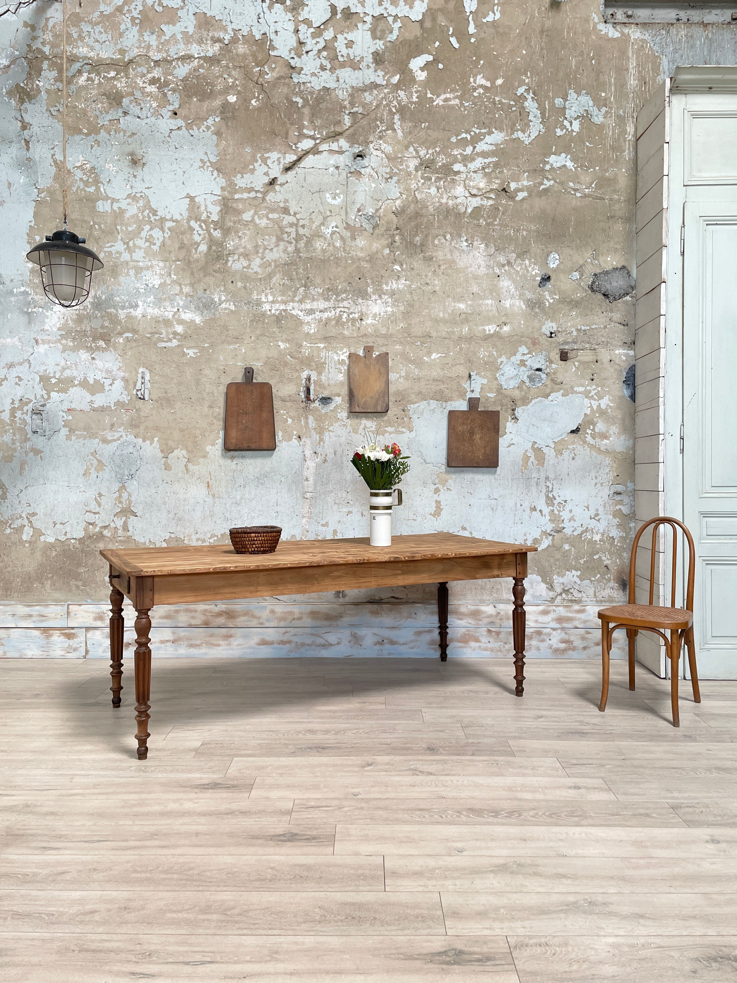 Vintage farmhouse table with turned legs.