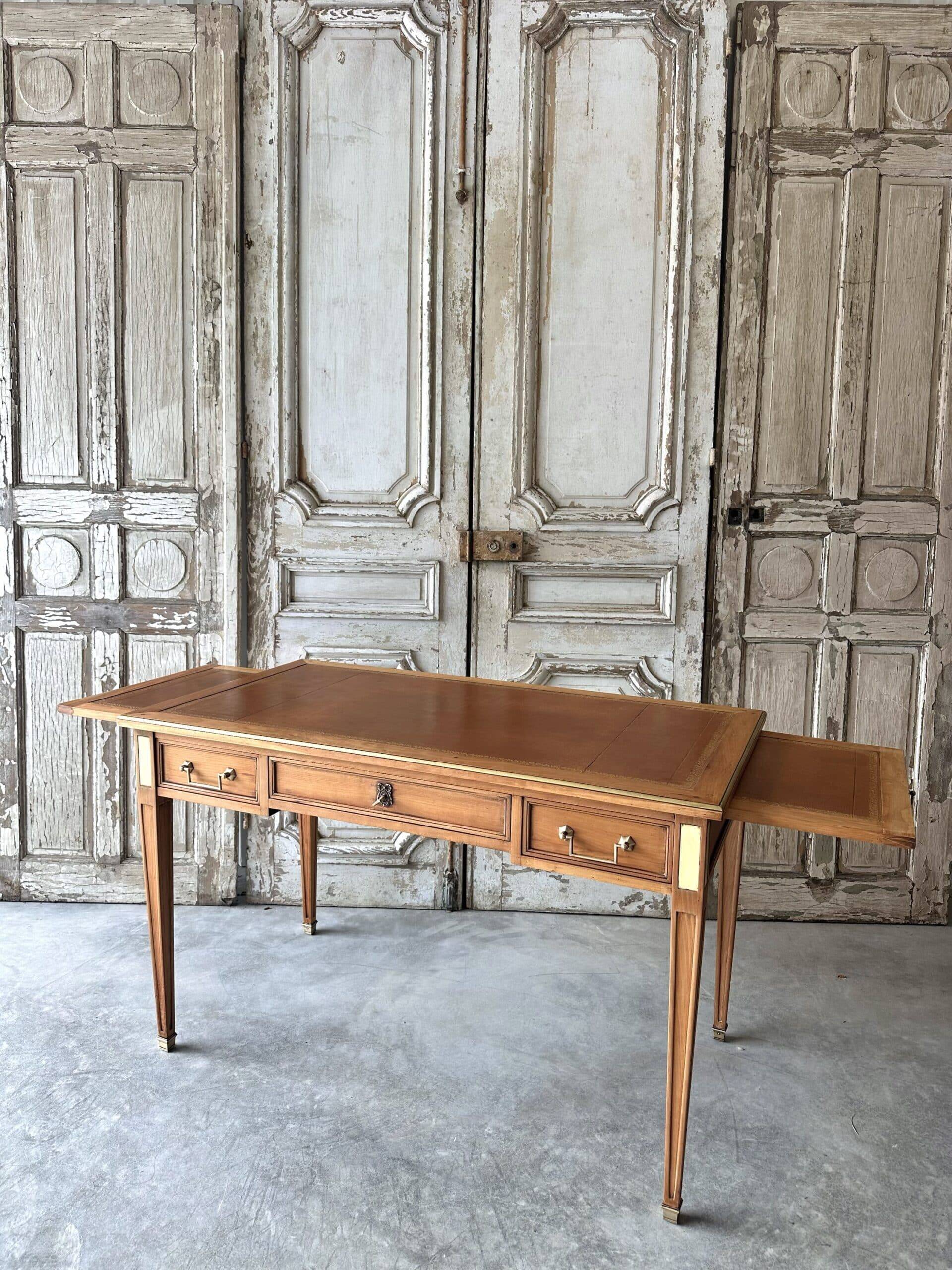 Directoire style flat desk circa 1960 in light cherry wood.