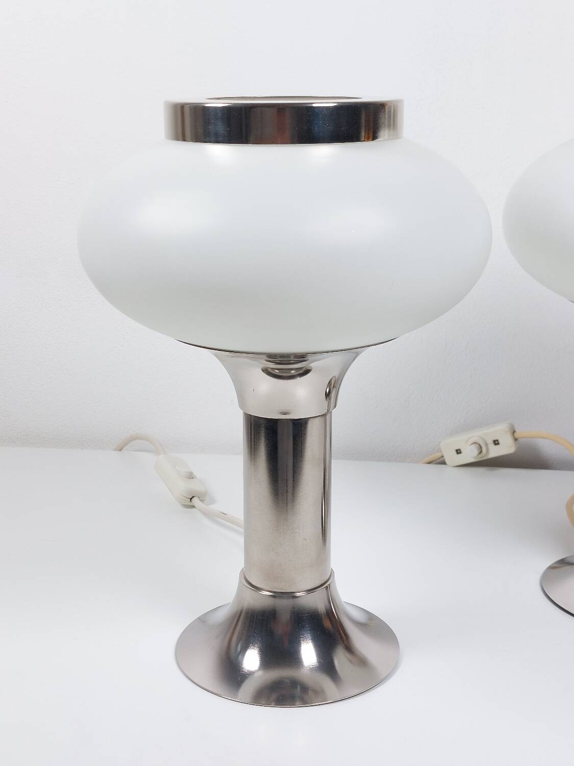 Pair of vintage futuristic style table lamps in chrome and opal glass.