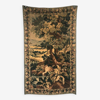 Tapestry decorated with a pink flamingo in a green landscape, woven by hand