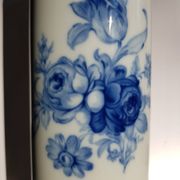 White porcelain vase from Limoges with blue decoration and gold rim.