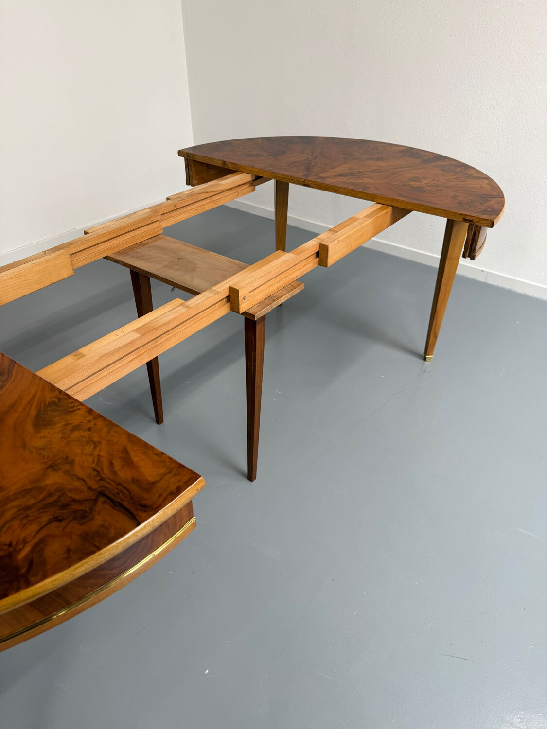 Round walnut Napoleon III extendable table with bronze top in good condition.