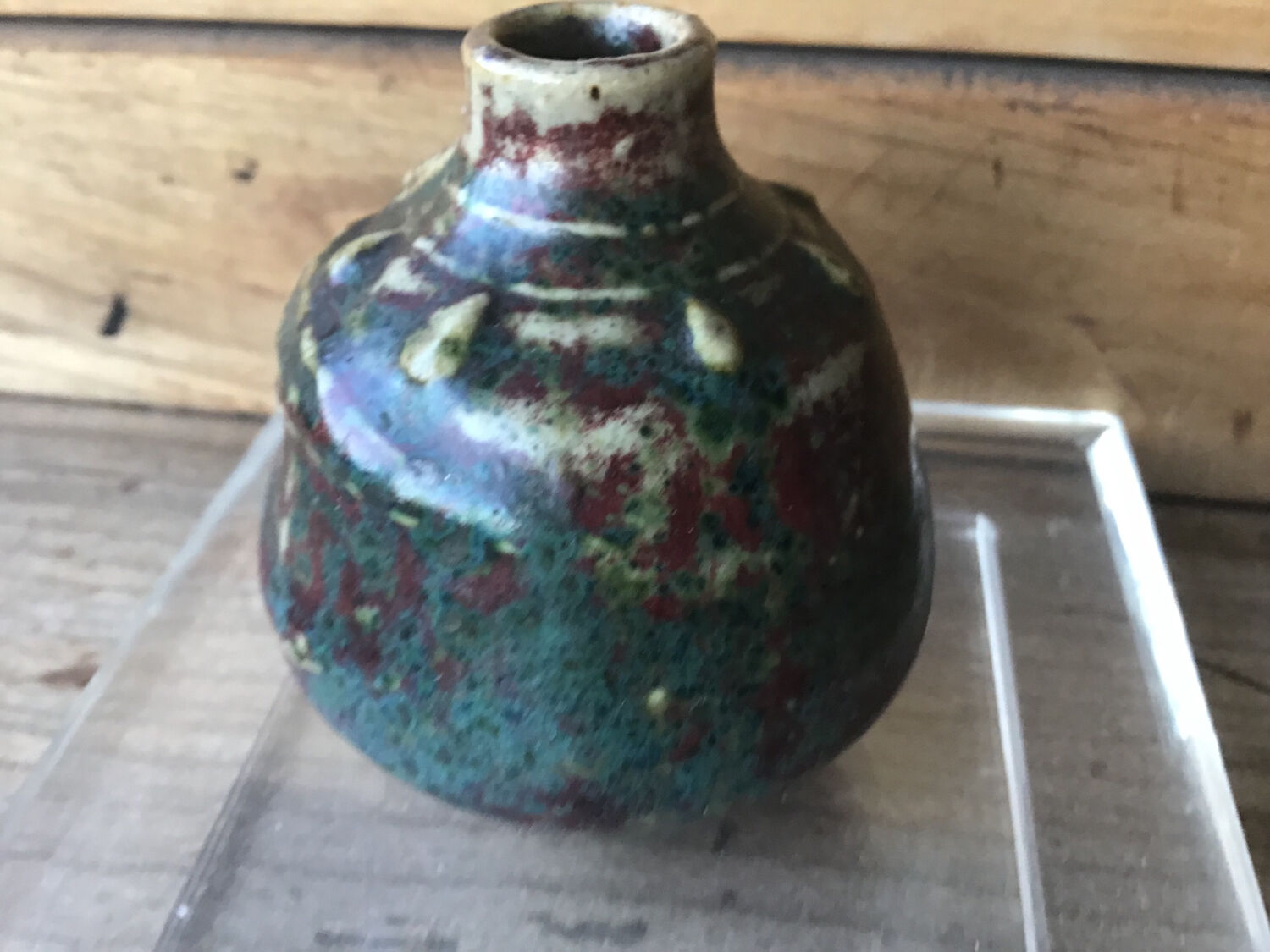 Small Dalpayrat vase shaped ball in polychrome glacured ceramic with relief decoration of a flower signed under the base