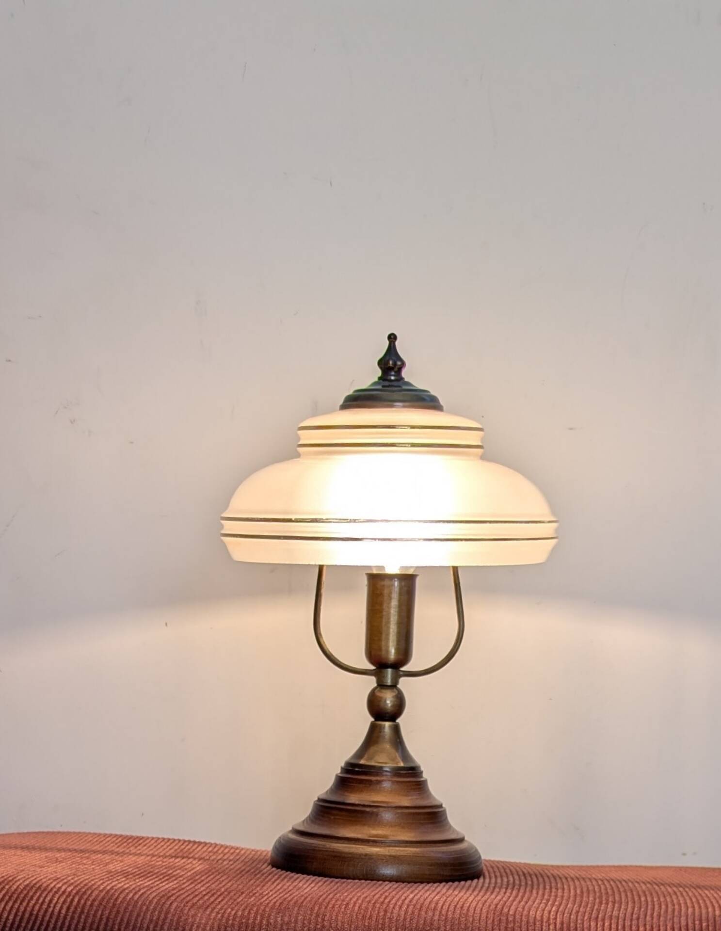 Vintage lamp made of turned wood, brass, and frosted glass.