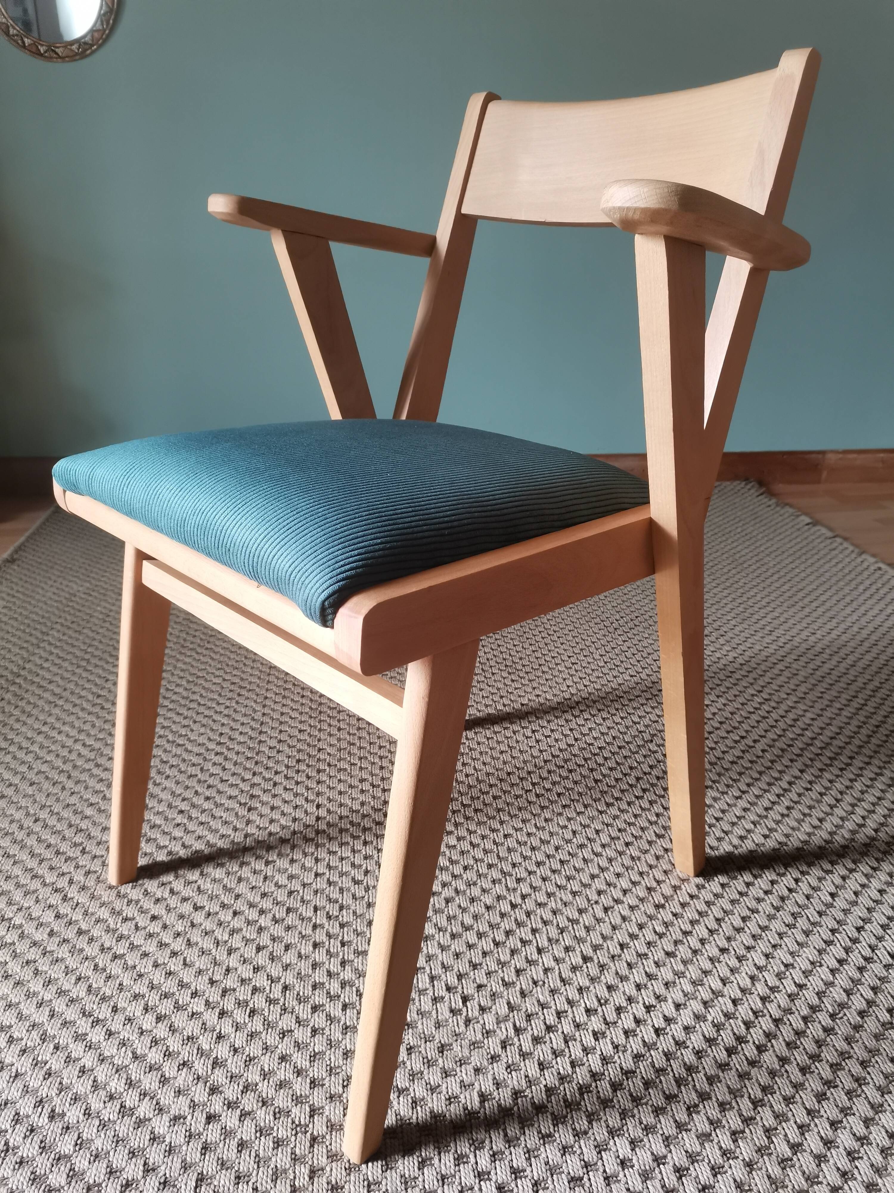 Scandinavian armchairs with green tapered legs.