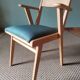 Scandinavian armchairs with green tapered legs.