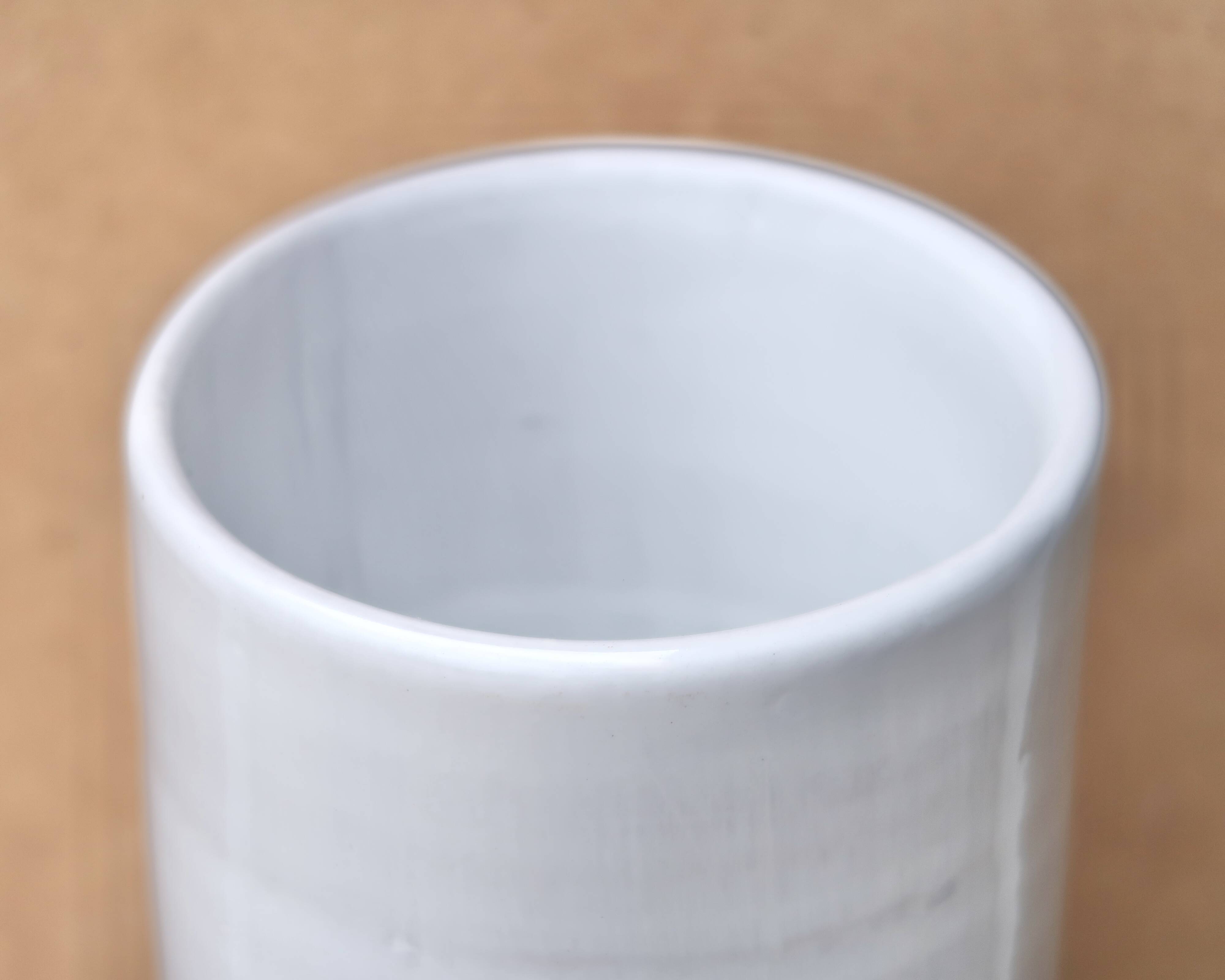 Vase by Antonio Lampecco minimalist white ceramic scroll