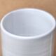 Vase by Antonio Lampecco minimalist white ceramic scroll