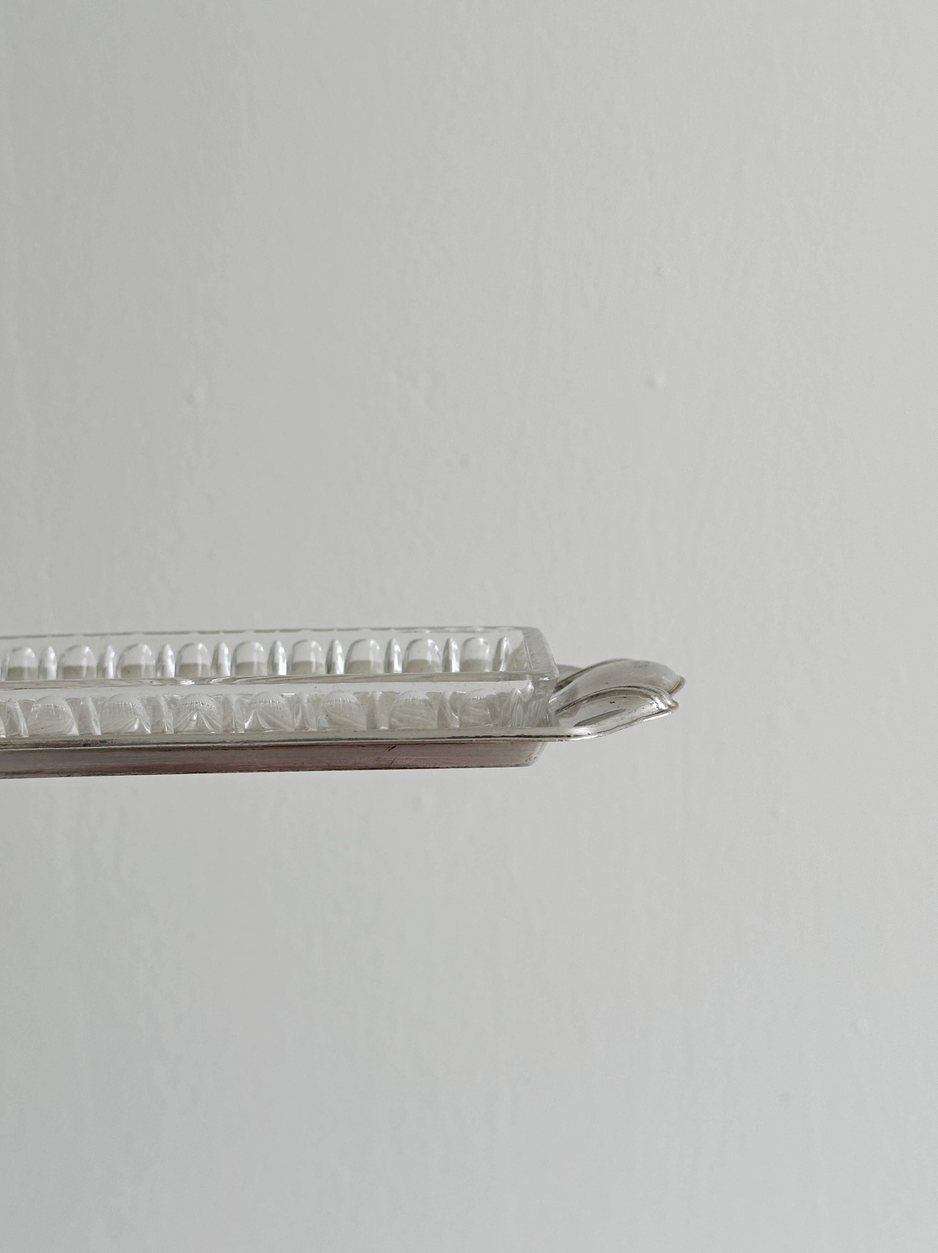 Metal butter dish and thick rectangular glass bowl.