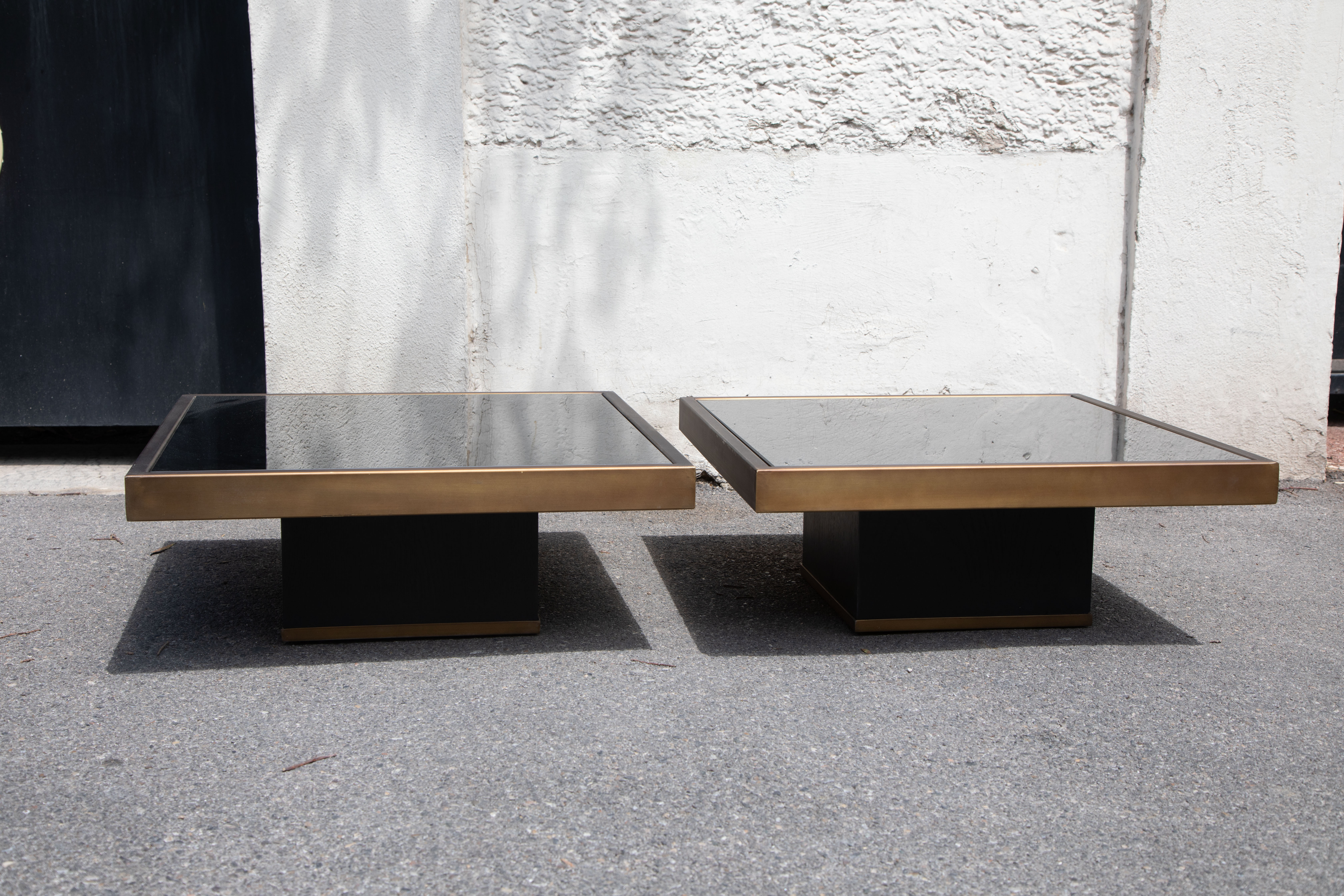 Pair of coffee tables brass black glass