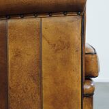 Sheep leather design armchair finished with decorative nails and black piping