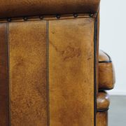 Sheep leather design armchair finished with decorative nails and black piping