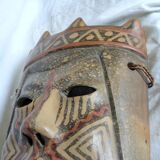Terracotta mask with geometric decorations