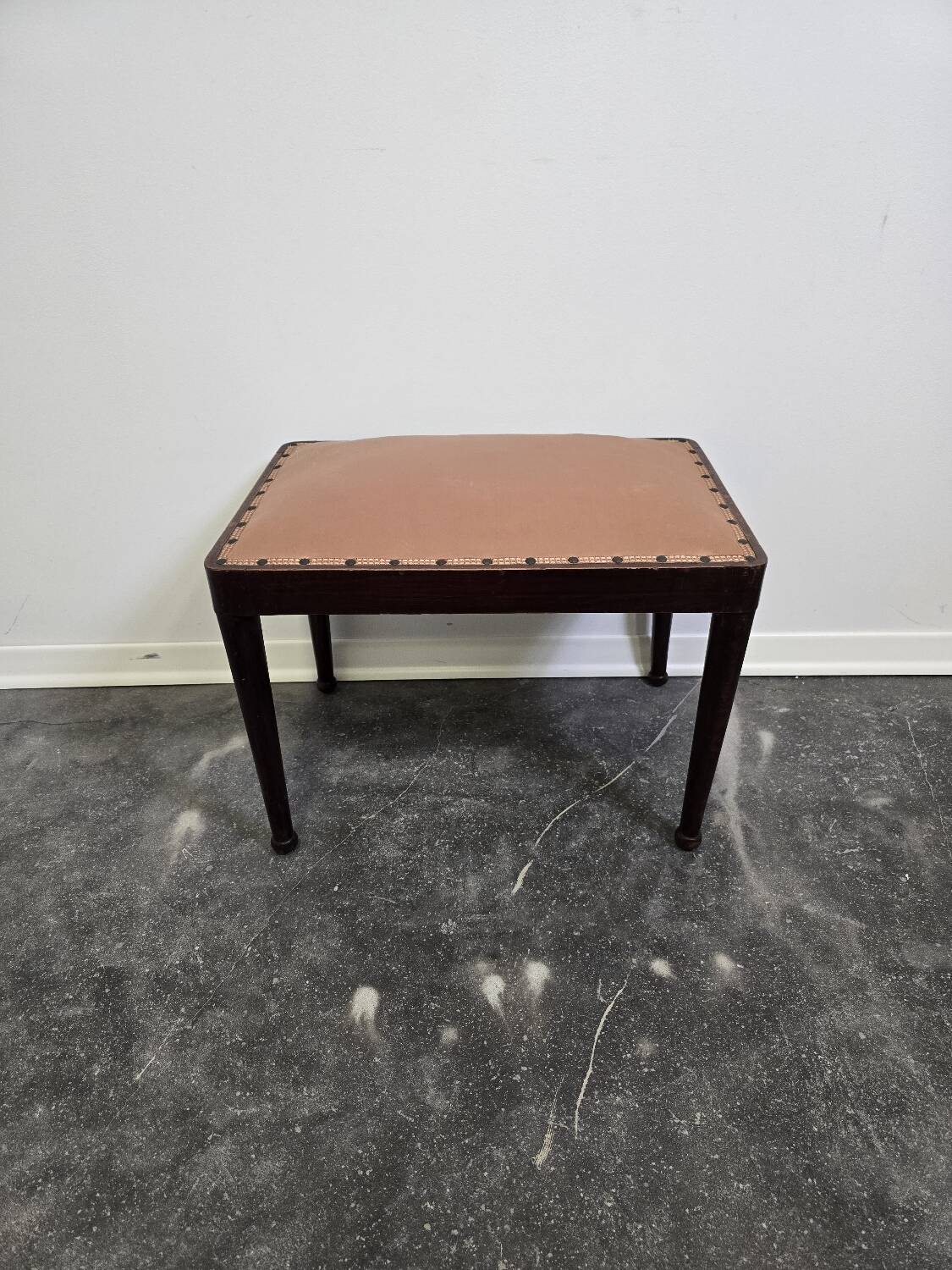 Vintage wooden ottoman from the 1940s with a silk top and studded trim.